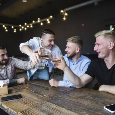 happy-friends-cheering-with-whisky-glasses-bar.jpg image 3